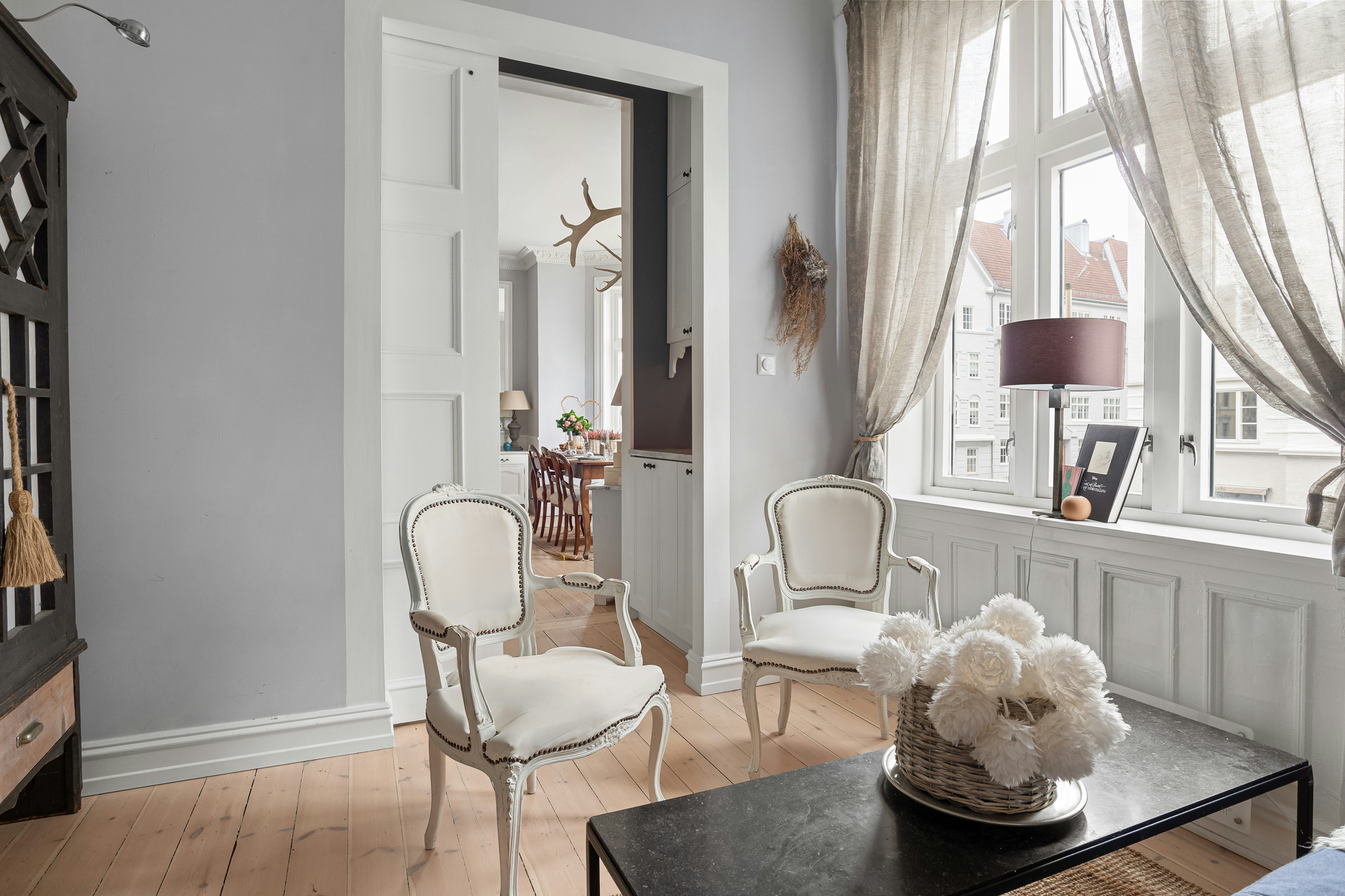 A living room filled with furniture and a large window